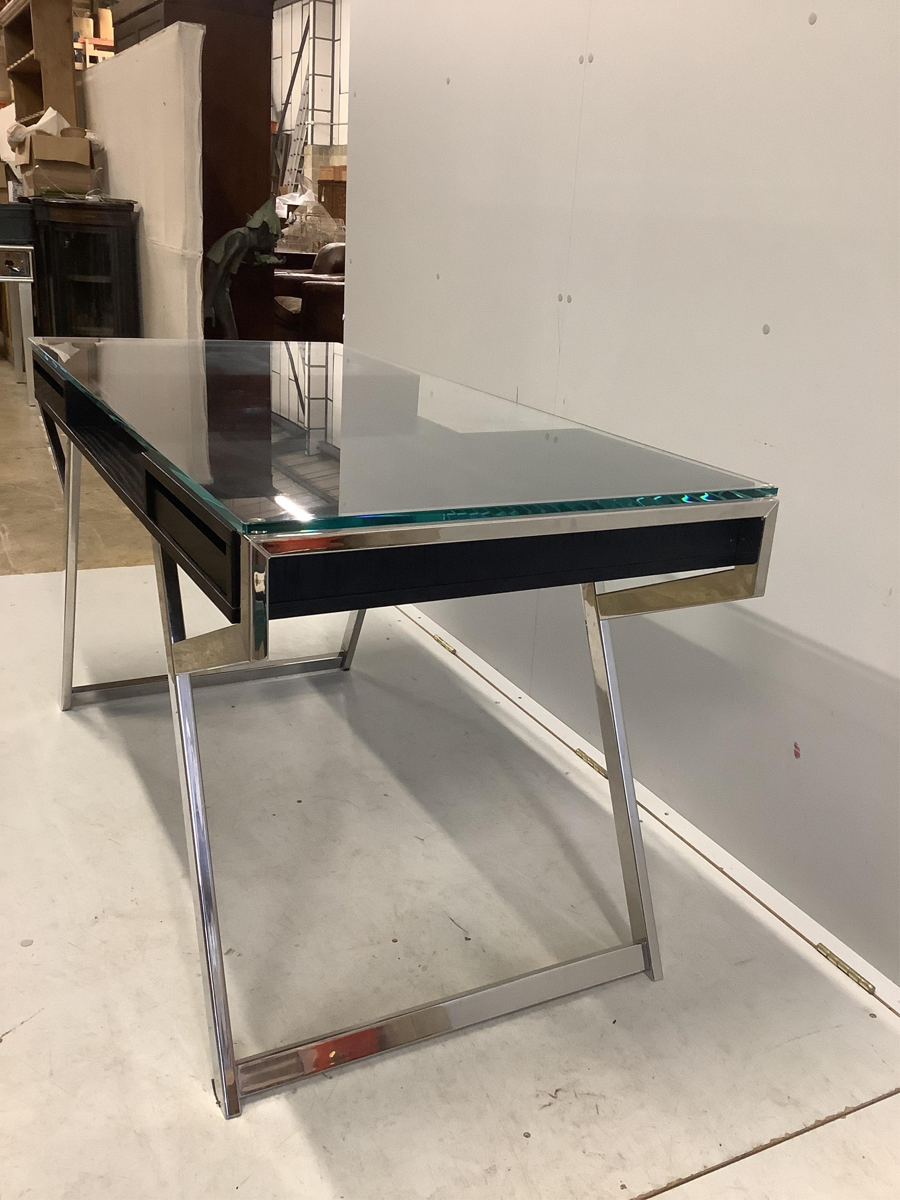 A Contemporary ash and chrome glass topped desk, width 140cm, depth 65cm, height 75cm. Condition - fair